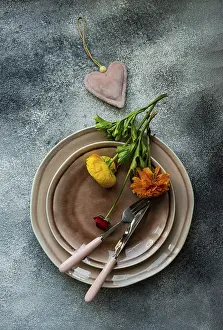 Deserted Table Scene Drucke: Rustic table setting with ranunculus flowers on concrete background with copy space