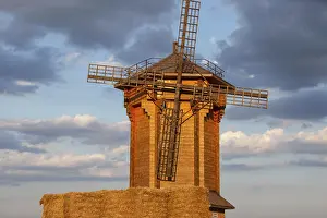 Evening Sun Setting Drucke: A rustic windmill is illuminated by sunset