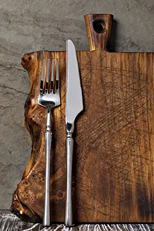 Rustic Wooden Cutting Board Drucke: Rustic wooden cutting board on rusty stone background