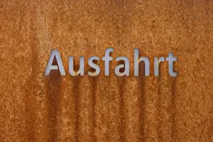 Rusty Metal Surface Drucke: Rusty metal surface with the word exit in modern script