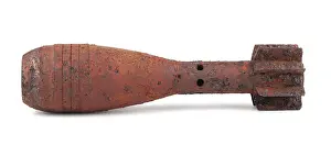 Studio Shot Of A Shell Drucke: Rusty mortar shell isolated on white background