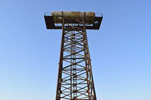 Deserted City Landmark Drucke: Rusty water tower. An old rustic communal communication