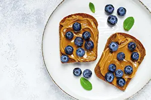 Rye Bread With Peanut Paste Drucke: Rye bread with peanut paste and fresh blueberries