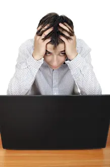 Caucasion Ethnicity Portrait Drucke: Sad and Troubled Young Man with Computer