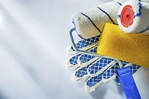 Protective Clothing Detail View Drucke: Safety gloves paint rollers on white surface