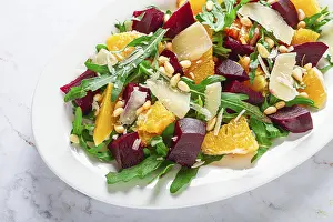 White Plate With Striped Napkin Drucke: A salad made with chunks of beet