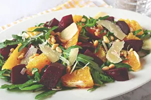 White Plate With Striped Napkin Drucke: A salad made with chunks of beet