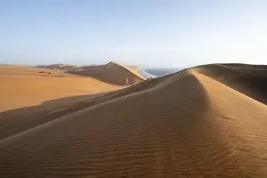 Nature Reserve Namibia Africa Drucke: Sand dunes with wave patterns and sea in evening light