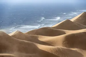 Namib Desert Landscapes Drucke: Sand dunes with wave patterns and sea in evening light