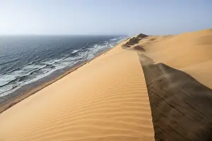 Namib Naukluft Park Drucke: Sand dunes with wave patterns and sea in evening light