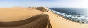 Sand Dunes Evening Light Drucke: Sand dunes with wave patterns and sea in evening light