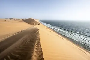 Namib Naukluft Park Drucke: Sand dunes with wave patterns and sea in evening light
