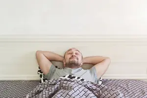 Break Of Dawn Image Drucke: A satisfied man is lying in bed