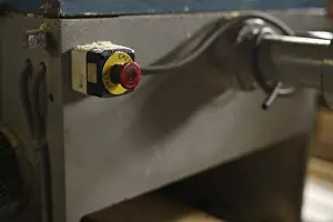 Industrial Building Architecture Drucke: At sawmill. Image of stop button on machine