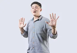 Dark And Gloomy Atmosphere Drucke: Scared man with raised hands isolated