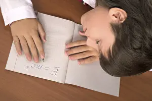Education Background Image Drucke: Schoolboy sleeping on the table with notebook