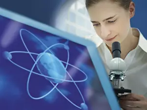 Caucasian Female Researcher Drucke: Scientist using a microscope, atomic structure on a monitor