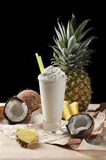 Coconut Cocktail Drucke: Selective focus composition with coconut cocktail served with pineapple