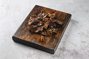 Roasted Meat Dish Drucke: Serving board with fried beef bacon strips