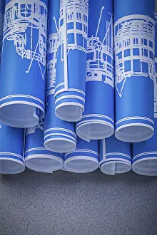 Blue Engineering Drawings Drucke: Set of blue rolled engineering drawings on grey background construction concept