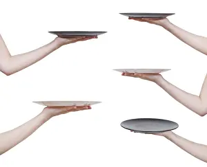 Meal Preparation Images Drucke: Set of flat plates on hand, against white background