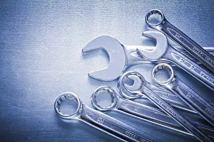 Metallic Background Drucke: Set of flat spanners and hook wrenches on metallic background construction concept