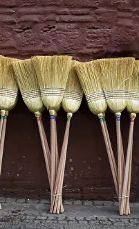 No People In The Market Drucke: Set of yellow straw broom in a bazaar