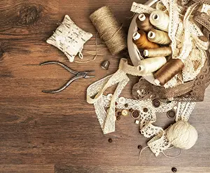 Handicraft Equipment Drucke: Sewing concept. Thread spools, buttons and sewing needles