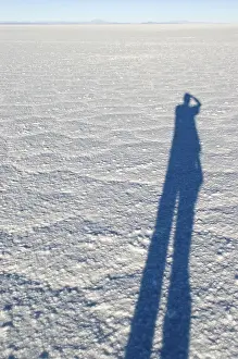 Lonely Man In Nature Drucke: Shadow of a man on the surface of Salar de Uyuni