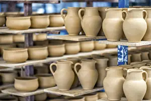 Ceramic Dishware Drucke: Shelves with ceramic dishware in pottery workshop