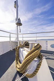 Boat Trip Europe Drucke: A ship deck with thick ropes and a bell