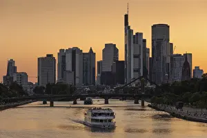 European Cityscape Drucke: A ship sails along the Main in the evening