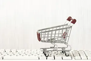 Online Shopping Concept Drucke: Empty shopping cart on computer keyboard