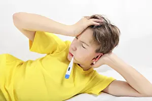 Sick Child Drucke: Sick Kid with Thermometer on the Bed