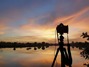 Atmospheric Light Photography Drucke: Silhouette of a camera at sunset