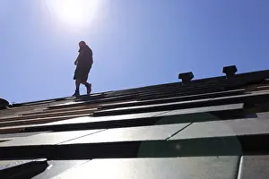 Handicraft Roofer At Work Drucke: Silhouette of a roofer against the light