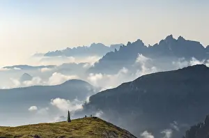 Southern Limestone Alps Photography Drucke: Silhouettes of mountains with small clouds in between