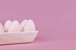Colorful Decorative Items Drucke: Simple one colored Easter eggs in egg tray on pink background with copy space