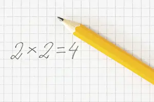 Deserted Classroom Scene Drucke: Simple math formula and pencil on squared paper
