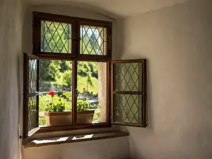 Deserted Stone Wall Drucke: Simple window wiht flower box in solid stone wall in old castle