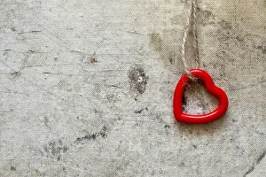 Symbolic Heart Shape Drucke: Single cute red heart hanging on the string