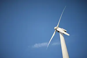 Ecofriendly Renewable Energy Drucke: Single wind turbine over dramatic blue sky and clouds
