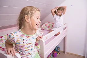 European Childhood Scene Drucke: Two sisters in bed, getting up
