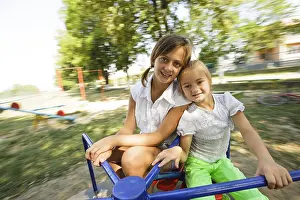 Childhood Memories Drucke: Two sisters on the carousel at the playground