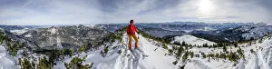 Alpine Lake Scenery Drucke: Ski tourer at the summit of Simetsberg