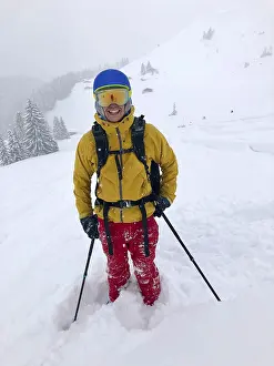 Snowy Mountain Peaks Europe Drucke: Skier in deep snow during snowfall