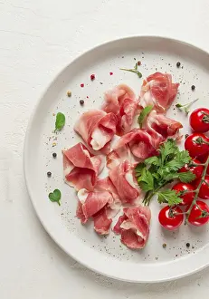 Sliced Prosciutto Drucke: Sliced prosciutto, appetizer, with cherry tomatoes