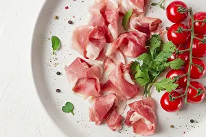 Sliced Prosciutto Drucke: Sliced prosciutto, appetizer, with cherry tomatoes