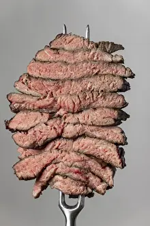 Steak Slices Drucke: Slices of steak on a grey background