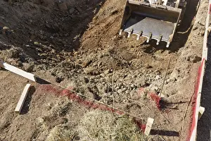 Pool Installation Process Drucke: Small bulldozer digging in yard for pool installation
